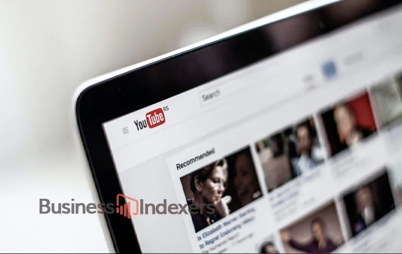 A laptop screen showing a YouTube homepage with recommended videos and business-related content ideas.