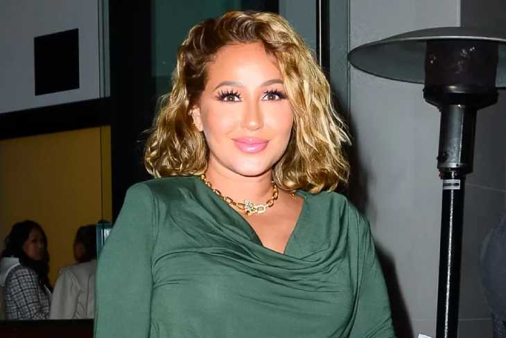 Adrienne Bailon net worth: Multi-talented star smiling, showcasing her success across music, television, and entrepreneurship that contributed to her $4 million fortune.