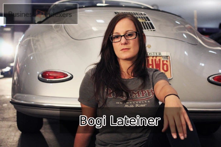 Bogi Lateiner sitting in front of a classic car, representing her achievements in the automotive industry.
