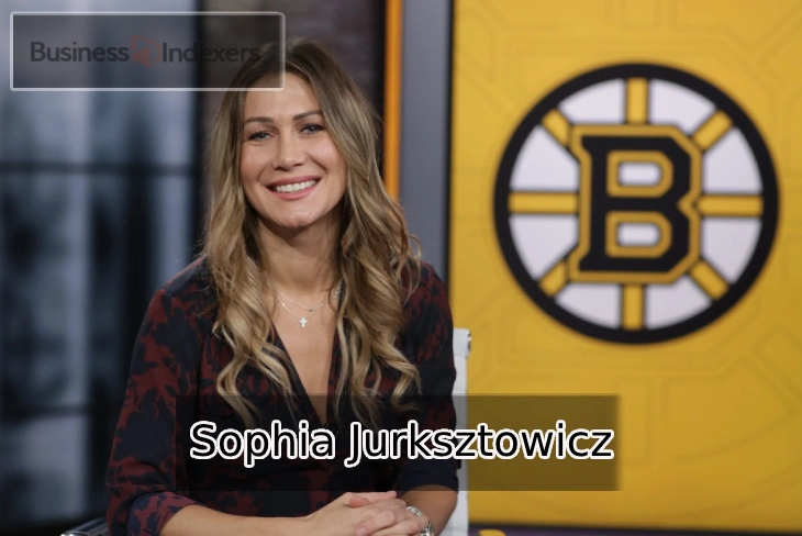 Sophia Jurksztowicz, NESN sports broadcaster, in front of the Boston Bruins logo.