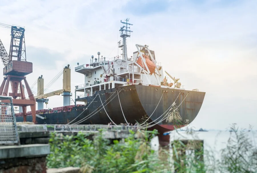 Ship repair Las Palmas dock with workers fixing a cargo vessel under clear skies